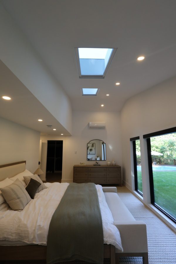 Bedroom with skylights and a window wall onto the garden